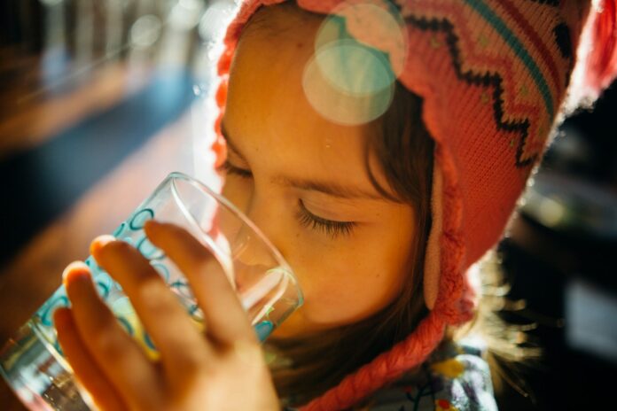 Photo by Johnny McClung selective focus photography of girl drinking water