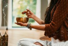 만성 피로 극복을 위한 자연 요법 woman in brown knit sweater holding brown ceramic cup