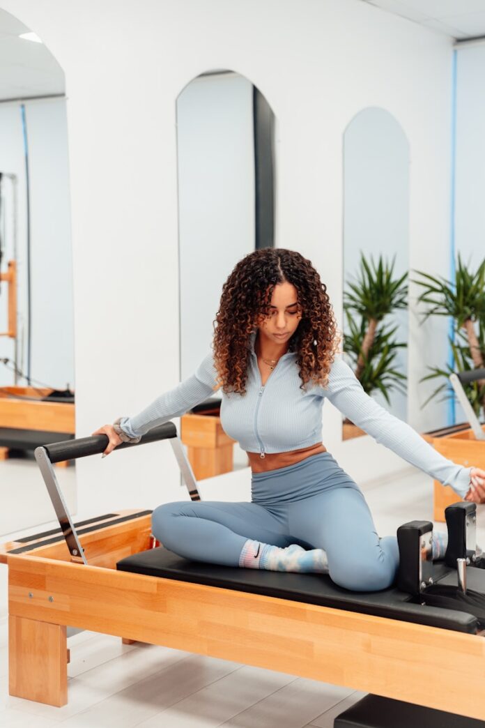 Photo by Ahmet Kurt a woman sitting on a piyor in a gym