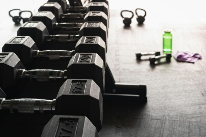 Photo by Greg Rosenke black and gray dumbbells on floor