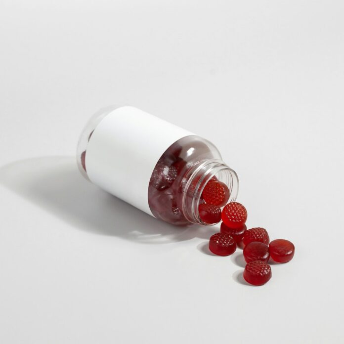 Photo by Supliful - Supplements On Demand a white salt shaker with red berries