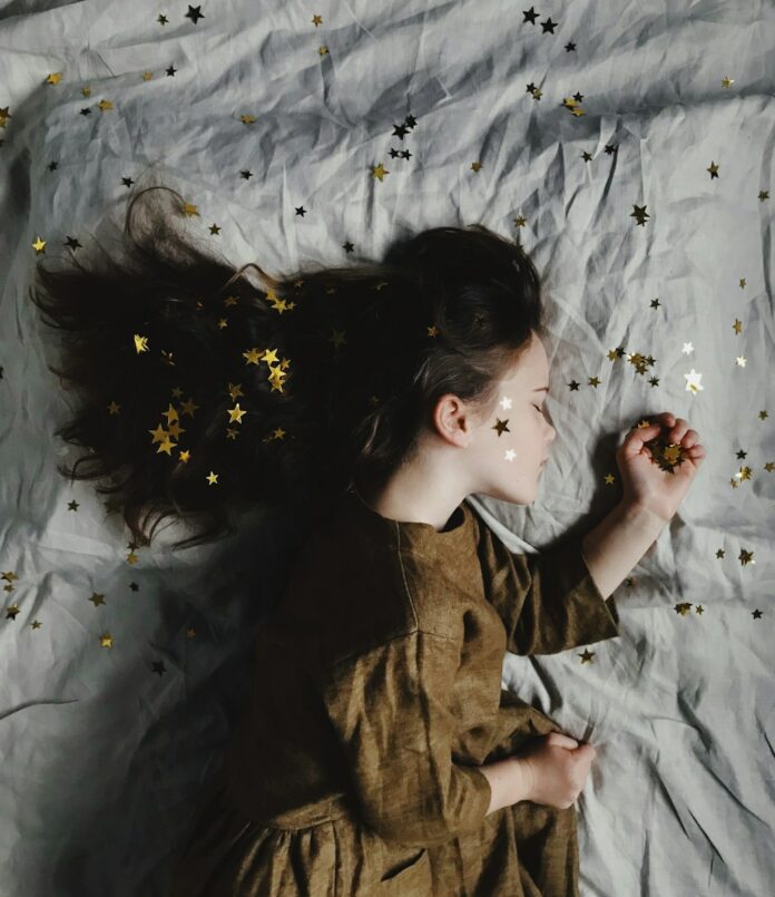 Photo by Annie Spratt woman in brown long-sleeved top sleeping on bed