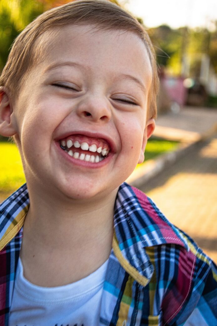 Photo by Amanda Sofia Pellenz boy in blue white and red plaid button up shirt smiling