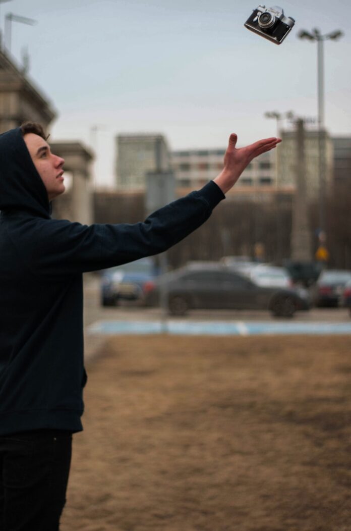 Photo by Jan Gerula selective focus photography of man reaching for black bridge camera