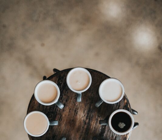 나를 위한 한 잔을 준비하는 그 시간이 좋아요. flat lay photography of eight coffee latte in mugs on round table