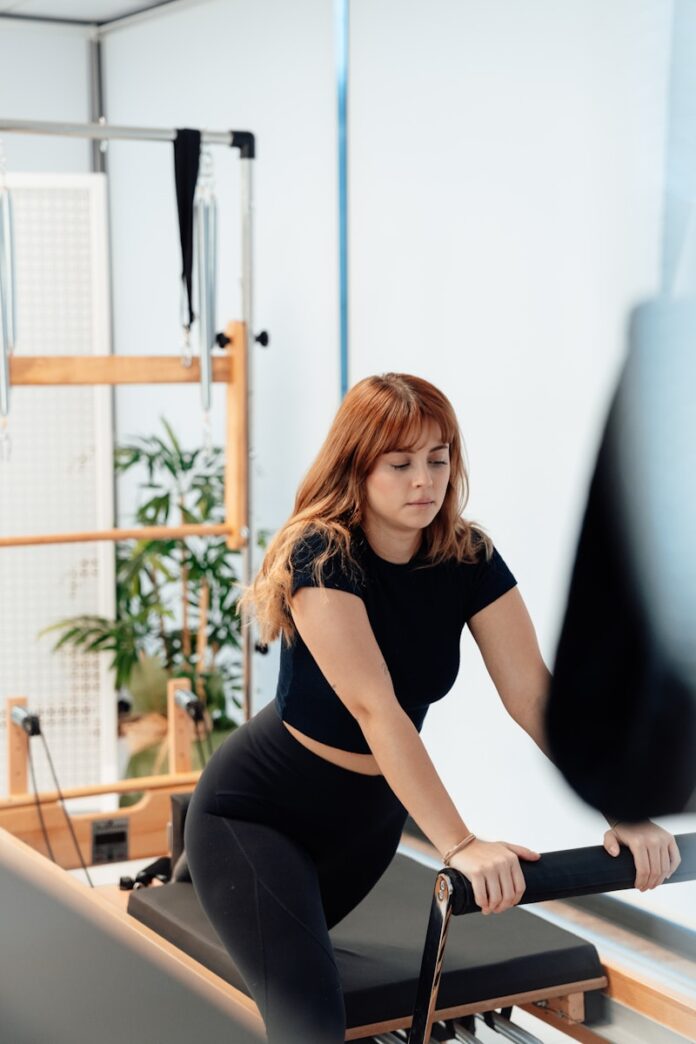 a woman on a rowing machine in a gym