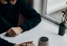 “마음챙김 루틴이 일상에 스며든다… 정신건강을 위한 작은 변화 실천법” person in black long sleeve shirt holding white ceramic mug