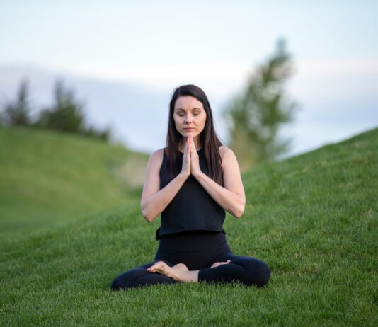 “나만의 웰니스 루틴, 일상에서 실천하는 건강한 문화 트렌드” woman in black tank top and black pants sitting on green grass field during daytime