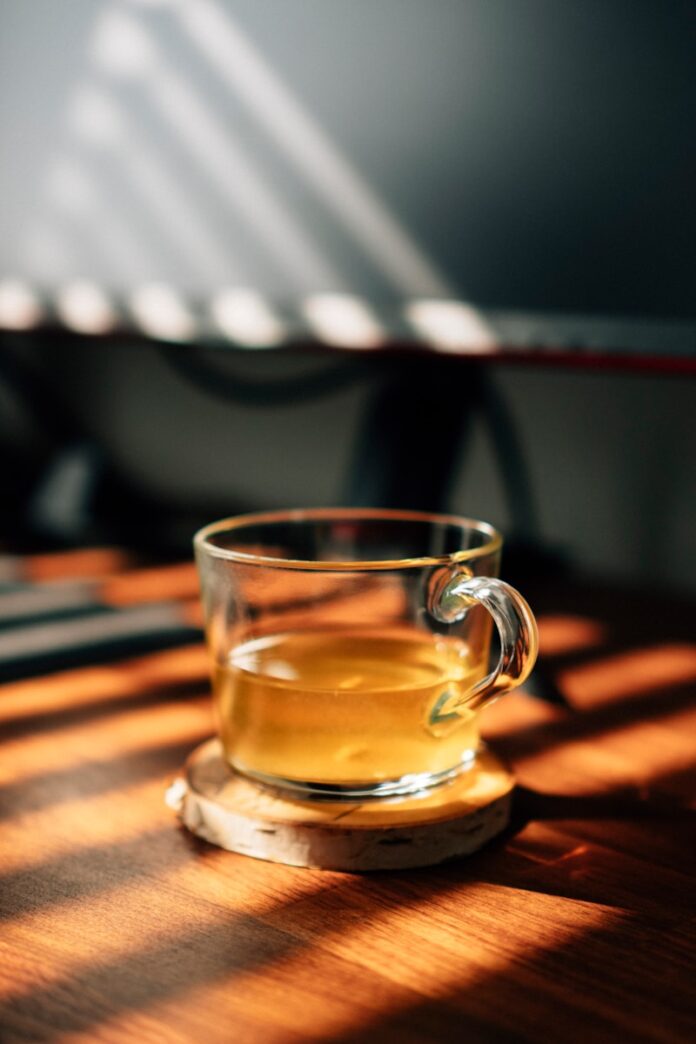 Photo by Luke Oslizlo clear glass mug on brown wooden table
