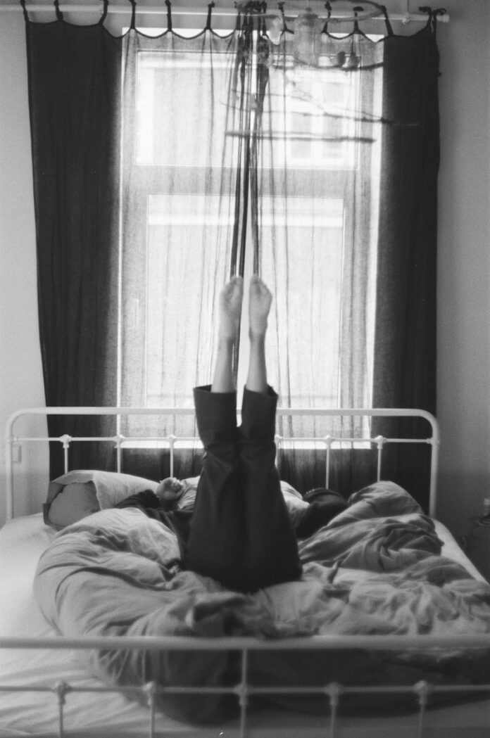 Photo by Kaspars Eglitis person laying on a bed