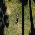 나만의 웰니스, 일상에서 실천하는 건강한 삶의 문화 woman lying on green grass during daytime