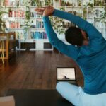 집콕 시대, 필라테스로 활력 찾기…일상 속 쉽게 시작하는 건강 루틴 a man doing yoga in a living room